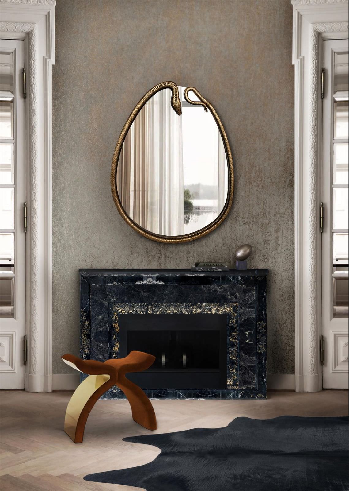 Framed in a coiled polished brass serpent form with a black jewel eye this mirror is the perfect way to add a touch of exoticism to any interior setting.