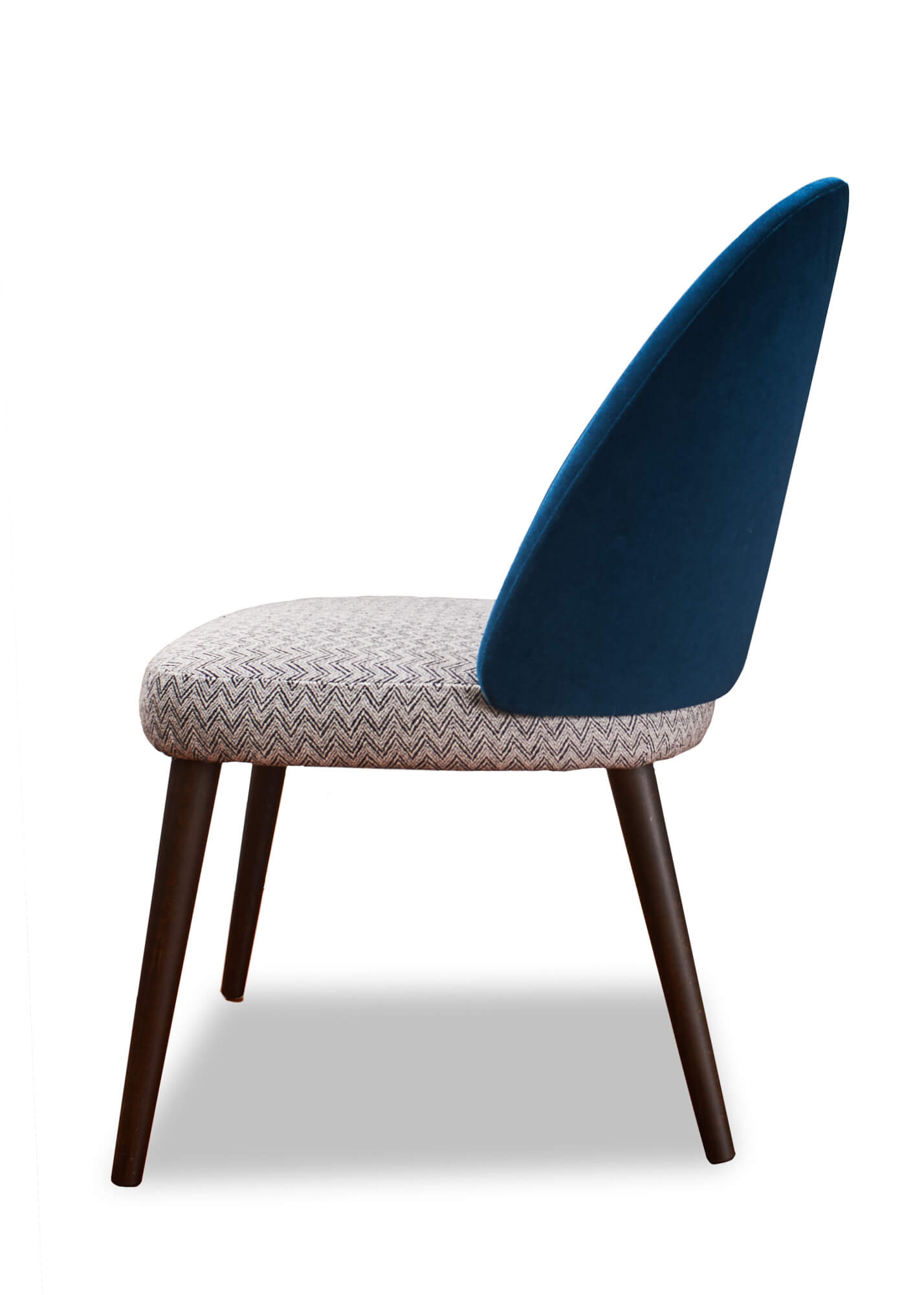 Smooth and stylish, this dining chair features a gracefully curved back and contemporary tapered legs.  Contrasting fabrics draw the eye to this attractive piece.